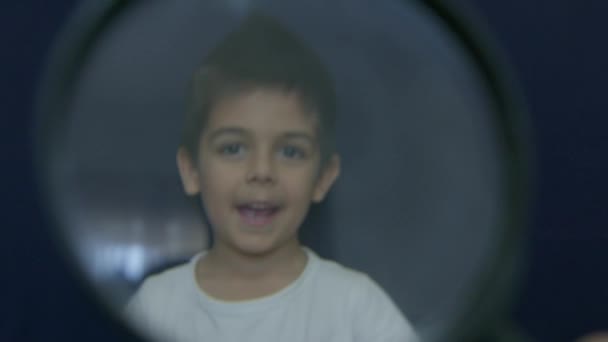 可爱的高加索学龄前男孩露出大拇指 透过放大镜观看 高质量的4K镜头 — 图库视频影像