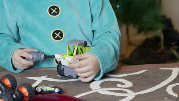 Cute Boy Elf Assembling Toys Kids Front Christmas Tree High — Stock Video