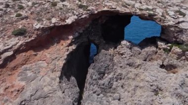 Kayalıklardaki doğal pencereler, Comino Adası Malta, İHA 'yı yakın çekim. Yüksek kalite 4k görüntü