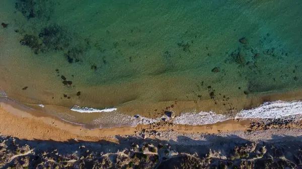 Altın kumsalda ve yeşil denizde sabah altın ışığı. Aerial, Malta, Ghajn Tuffieha Körfezi. Yüksek kalite fotoğraf