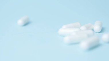Açık mavi arka planda beyaz haplar. Yüksek kalite fotoğraf