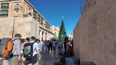 Valletta, Malta - Valletta şehrinin 25.11.2024 Kapısı köprüsü, insanlar parlamento binasının önünde Noel ağacı yakınında toplanıyor. Yüksek kalite 4k görüntü