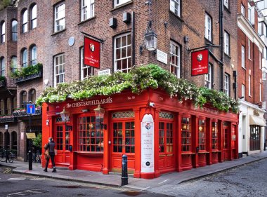 İngiltere, Birleşik Krallık, 2 Kasım 2022, Mayfair 'deki Chesterfield Arms barının önünden geçen bir kadının görüntüsü