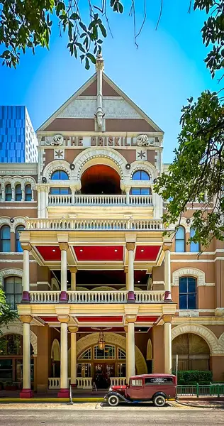 stock image Texas, USA, May 29th 2024, view of a vintage car parked outside The Driskill, a luxury hotel on the corner of 6th Street and Brazos Street