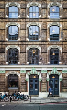 London, UK, Aug 18th 2025, view of a man walking by the Menier building in Southwark Borough.