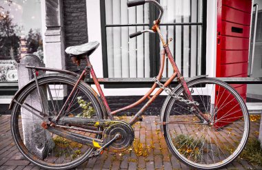 Amsterdam, Hollanda. Sokağa park edilmiş eski bir bisiklet. Sağlıklı yaşam tarzı için eski usul ulaşım.