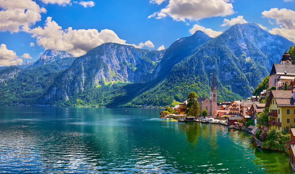 Hallstatt old town in mountains Alps Austria. Scenic landscape with view on lake. Ancient european village among Mountains and green trees. Famous travel destination in Europe.