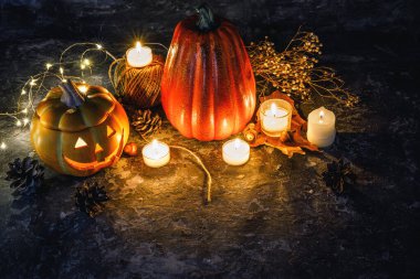 Cadılar Bayramı. Yanan mumlarla balkabağı dekorasyonu ve metin için koyu kırsal arka plan telif alanı üzerinde kriko-fener yüzü