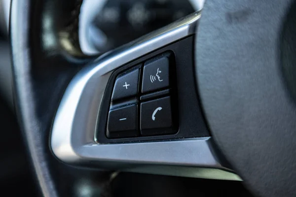 Detail of Hands-free buttons on the steering wheel of the car
