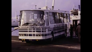 Tindari, Italy june 1975: Bus disembarks from the ferry and continues its journey scene in 70s