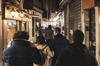 Venice, Italy 6 January 2023: Crowd of people in Venice scene at night