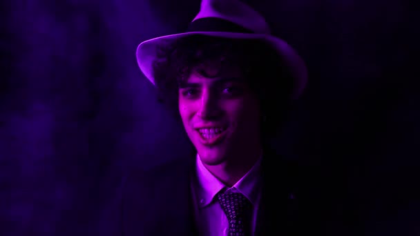 Young Curly Haired Brunette Man Hat Suit Looks Camera Smiles — Video Stock
