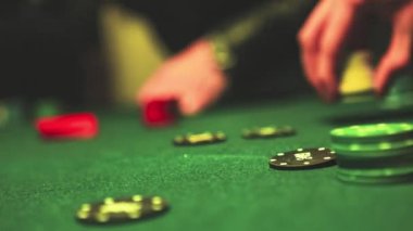 Close up of man hands stacks up poker chips on the table casino gambling concept