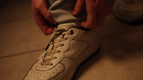 Man Adjusts His Jeans White Sneakers Shows Attention Detail Comfort — Wideo stockowe