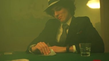 Poker players disappointed look as he drops the cards on the table during a game