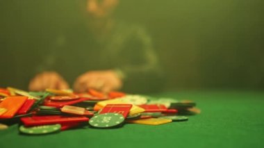 Chaotic scene of poker game with scattered chips on table hinting at high stakes