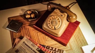 New York, United States 17 January 2023: A man's hand picking up the receiver of an antique telephone placed on a table, lifting it up and off the hook. And then putting the receiver back onto the hook, returning it to its original position.