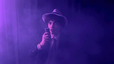 A playful and energetic young man singing a song. With a microphone in hand and a mischievous twinkle in his eye. Talented performer with his infectious energy and hilarious facial expressions.