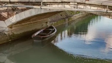 Wooden Boat Moored Under the Bridge