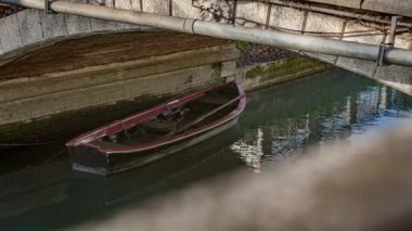 Wooden Boat Moored Under the Bridge