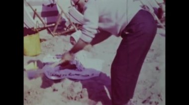 Rimini, Italy june 1975: A nostalgic trip down memory lane with this historical video capturing children on the beach during their summer vacation in the 70s.