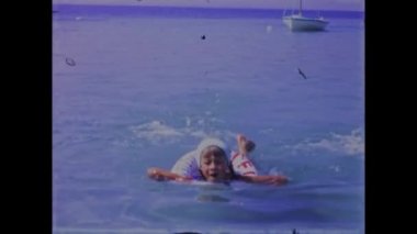 Pakostane, Croatia May 1968: Relive the golden moments of family beach vacations in the 70s with this vintage video footage. Featuring scenic views of the ocean and happy families playing together