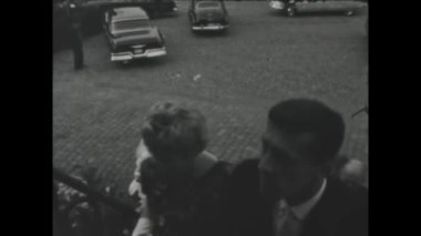 Thimister-Clermont, belgium may 1970: A historic video showcasing a wedding scene outside a church in the 1970s.