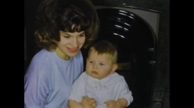 Thimister-Clermont, belgium may 1970: A historic footage of a Christmas scene in a family home with gifts, creating memorable moments in 70s