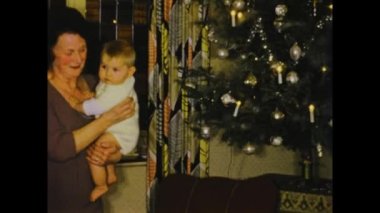 Thimister-Clermont, belgium may 1970: A historic footage of a Christmas scene in a family home with gifts, creating memorable moments in 70s