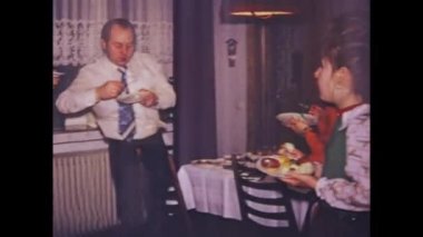 Stuttgart, Germany may 1975: Relive the good old days with this vintage video of a 70s home dinner party, capturing the joy and togetherness of friends and family.