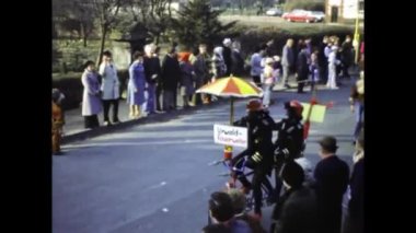 Berlin, Germany march 1975: A historical video of a bustling street carnival parade featuring vibrant and elaborate themed floats from the 1970s