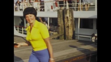 Berlin, Germany june 1975: A historic video showing passengers disembarking from a ferry at the dock and then departing in the 1970s, capturing transportation and movement during that time.