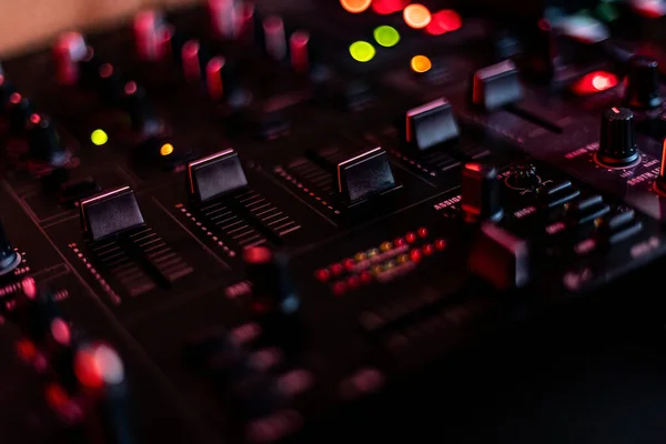 Close-up of an audio mixer with knobs and buttons, perfect for music production and audio engineering projects