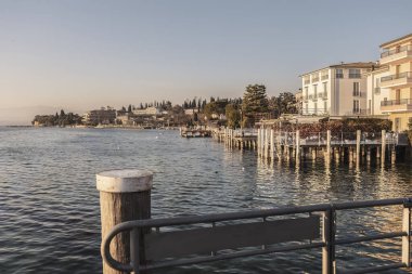 Capture the beauty of Sirmione's sunset with this stunning landscape photo. The vibrant colors and serene atmosphere make for a perfect wall art or background for any project