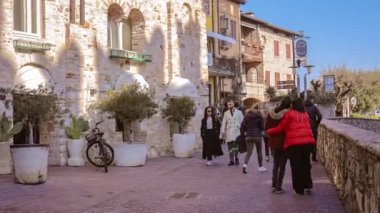 Sirmione, Italy 16 February 2023: Charming historic center of Sirmione, a popular tourist destination on Lake Garda in Italy, bustling with visitors exploring its narrow streets and ancient buildings.
