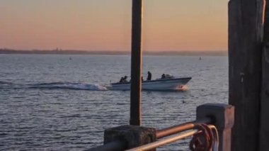 Sirmione, Italy 16 February 2023: A group of tourists enjoying a boat ride on the picturesque Lake Garda in Italy, surrounded by stunning mountains and clear blue waters.