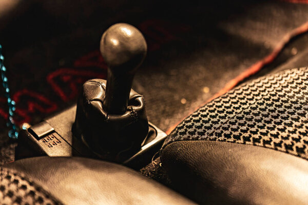 Close-up of a classic car gear shift lever and knob.