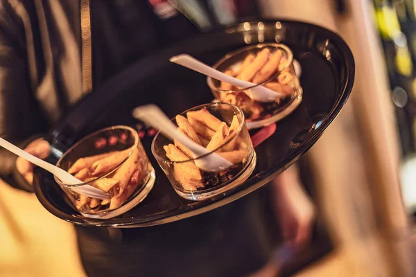 stock image A close-up shot of a tray featuring three mini pasta appetizers, perfect for entertaining guests.