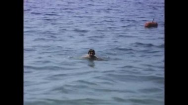 Zadar, Hırvatistan Haziran 1970: 1970 'lerdeki plaj tatili sırasında ışıl ışıl denizde yüzen bir adamın tasasız anlarına şahit olduğunuz gibi nostaljiye dalın.