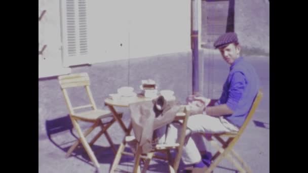1960年6月 ヴィンテージ映像は 1960年代の小さなテーブルで屋外で朝食を楽しんでいる男を捉えています — ストック動画