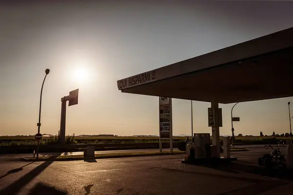 Stock image Adria, Italy 30 july 2024: Multiple cars parked at a gas station during sunset with long shadows.