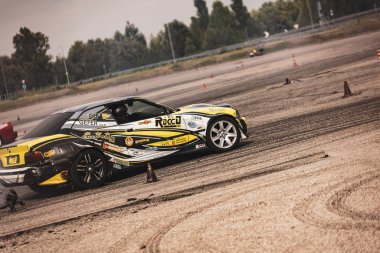 Villamarzana, Italy 17 September 2024: A customized yellow and black drift car in action during a motorsport event. clipart