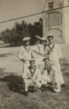 Rome, Italy may 1964: Six cheerful sailors in uniform posing for a photo in front of a building, capturing a moment of camaraderie during their service clipart