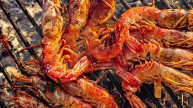 Dev kırmızı Arjantin karidesi barbeküde ızgara yapıyor. Düğün yemeği için bir aşçı tarafından bakılıyor.