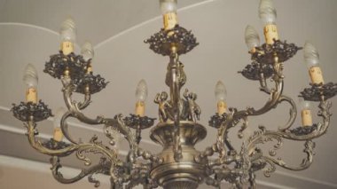 Zarif antika bir avize Tavandan sarkan mum şeklindeki ışıklarla