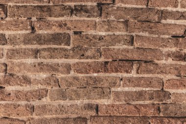 Kahverengi tuğla duvar dokusu, eski tuğla işçiliğinin eskimiş güzelliğini tam bir çerçeve içinde sergiliyor.