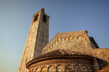 Garda Lake, Italy 3 January 2025: San severo church in bardolino, italy, showcases its stunning romanesque architecture and towering bell tower against a clear blue sky clipart