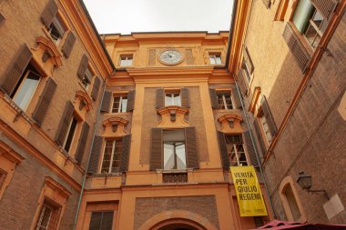 Modena, Italy 1 January 2025: Low angle view of palazzo ducale in modena, italy, featuring a clock and a banner seeking justice for giulio regeni clipart