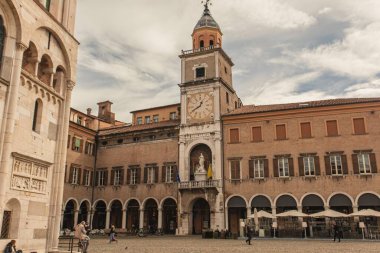 Modena, İtalya 1 Ocak 2025: Bulutlu bir günde Emilia-Romagna 'nın tarihi bir şehri olan Modena' daki saat kulesi ve katedrali ile Piazza Grande manzarası