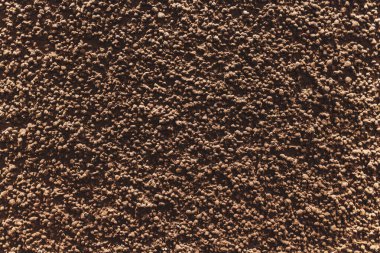 Kaba, desenli, kahverengi renkli bir duvarın yakın görüntüsü, çeşitli tasarım uygulamaları için eşsiz ve çekici bir arkaplan sağlar